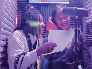 two students in a recording studio
